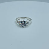 Round 7mm Solitaire With Two Small Stones Ring