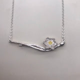 Silver lotus on a double branch with gold necklace